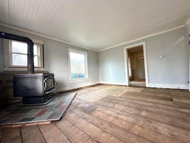 unfurnished living room featuring dark hardwood / wood-style flooring, a wood stove, and crown molding