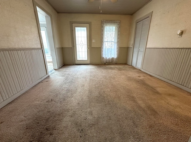 empty room featuring carpet and ceiling fan