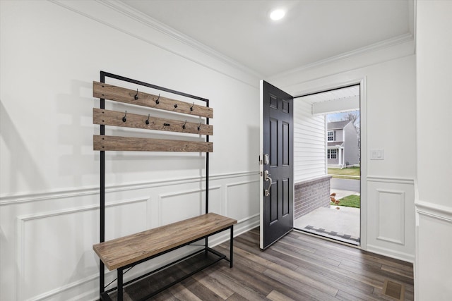 entrance foyer with dark hardwood / wood-style floors and crown molding