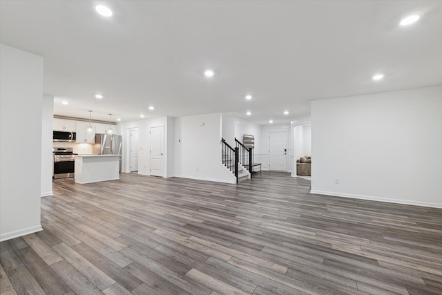 unfurnished living room with wood-type flooring