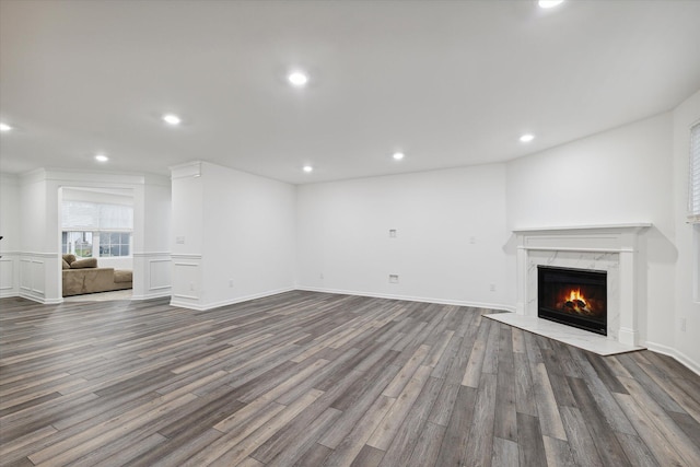 unfurnished living room with a fireplace and dark hardwood / wood-style floors