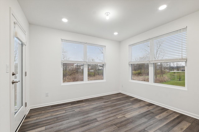 unfurnished room with dark wood-type flooring