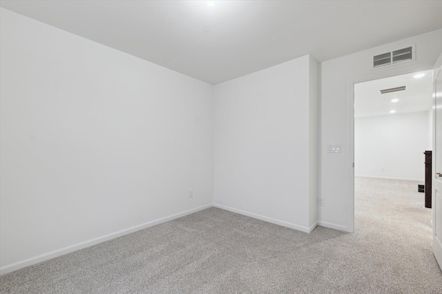 unfurnished room featuring light colored carpet