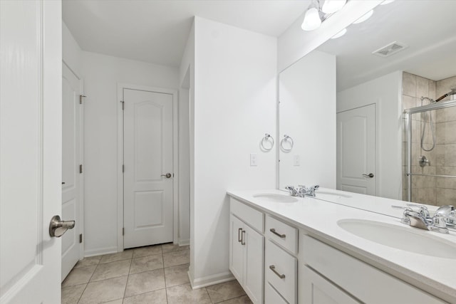 bathroom featuring tile patterned floors, vanity, and walk in shower