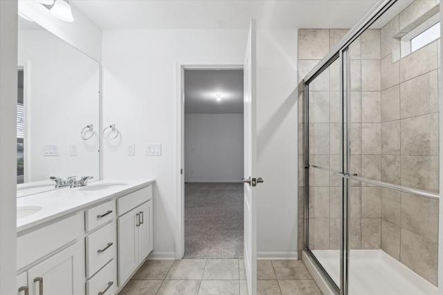 bathroom featuring tile patterned floors, vanity, and a shower with door