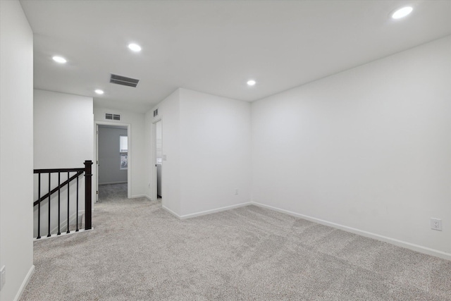 empty room featuring light colored carpet