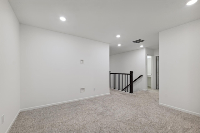 empty room featuring light colored carpet