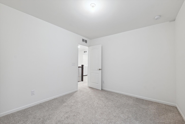 unfurnished room featuring light colored carpet