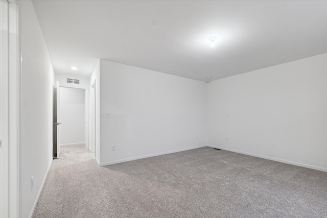 unfurnished room featuring light carpet