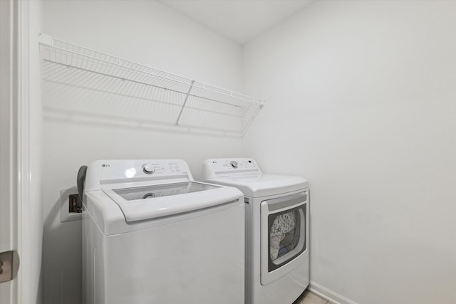 clothes washing area featuring separate washer and dryer