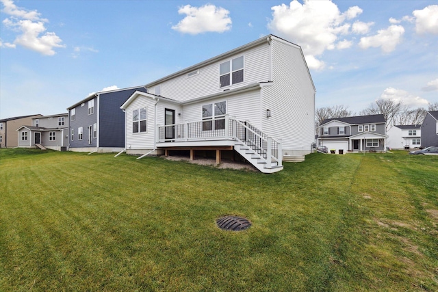 rear view of property with a yard and a deck