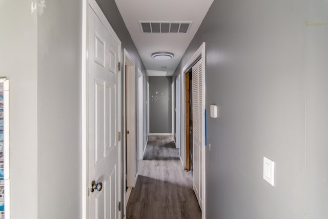 corridor featuring dark hardwood / wood-style flooring