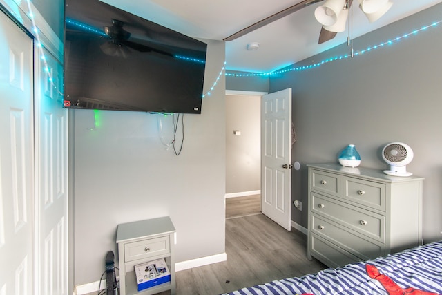 bedroom with ceiling fan and dark wood-type flooring