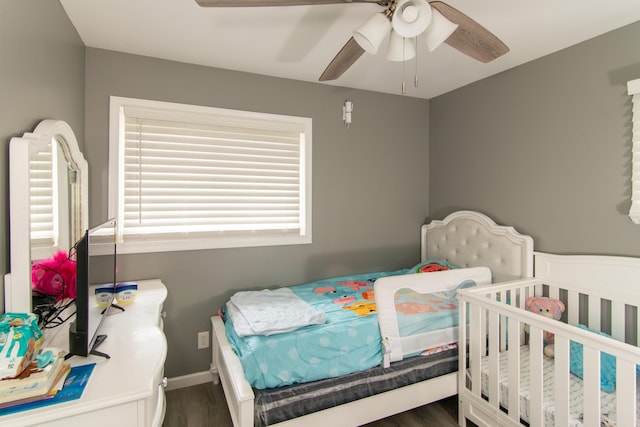 bedroom featuring ceiling fan and dark wood-type flooring