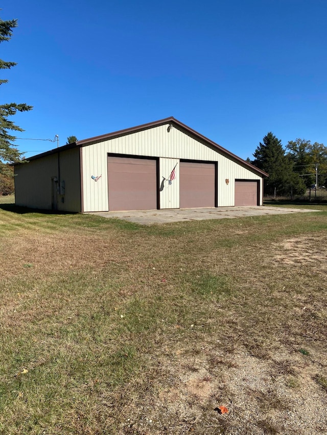 view of outbuilding with a yard and a garage