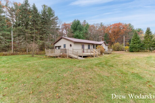 exterior space featuring a lawn and a wooden deck