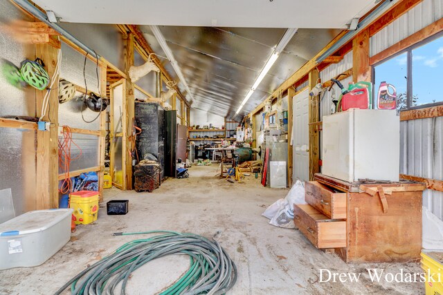 miscellaneous room with a workshop area and concrete floors