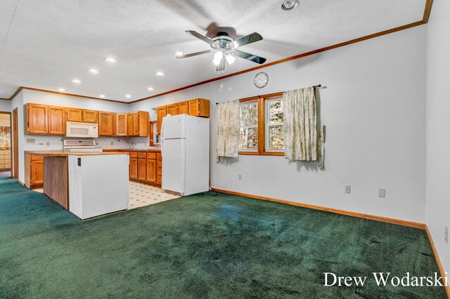 kitchen featuring light carpet, ornamental molding, white appliances, ceiling fan, and a center island