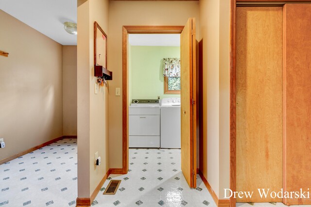 corridor featuring washer and clothes dryer