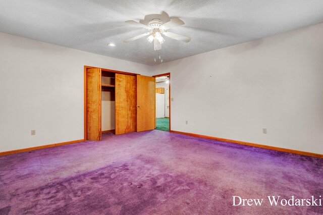 unfurnished bedroom with carpet, a closet, and ceiling fan