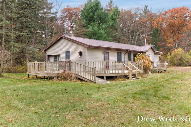 view of front of house featuring a front yard and a deck