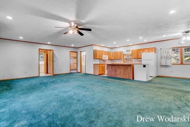 kitchen with carpet flooring, white appliances, ceiling fan, and ornamental molding