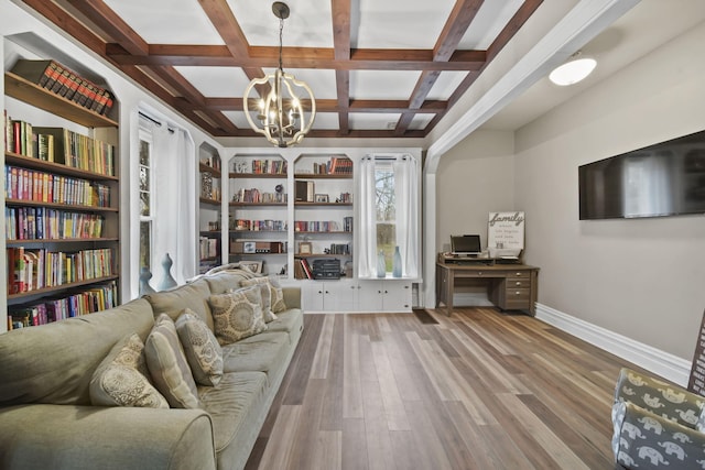 sitting room with an inviting chandelier, beamed ceiling, coffered ceiling, and hardwood / wood-style flooring