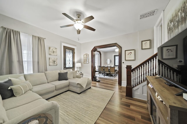 living room featuring dark hardwood / wood-style floors, ceiling fan, and plenty of natural light