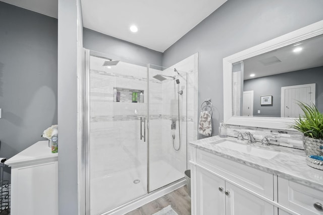 bathroom with walk in shower, tasteful backsplash, wood-type flooring, toilet, and vanity