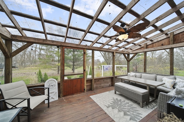 sunroom featuring ceiling fan, plenty of natural light, and lofted ceiling