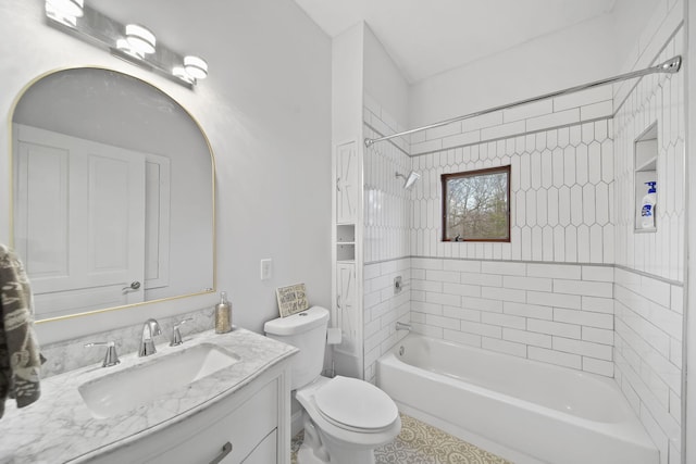 full bathroom featuring tiled shower / bath, vanity, and toilet