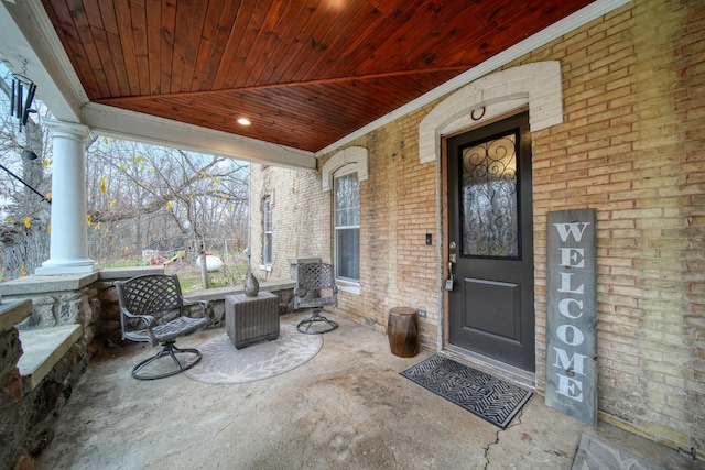 view of exterior entry featuring a porch