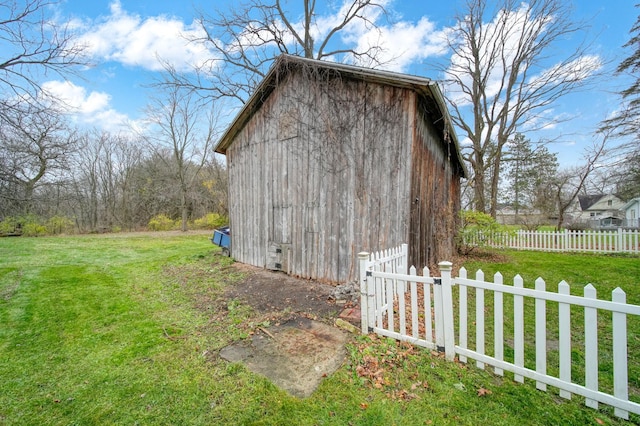 view of outbuilding featuring a lawn