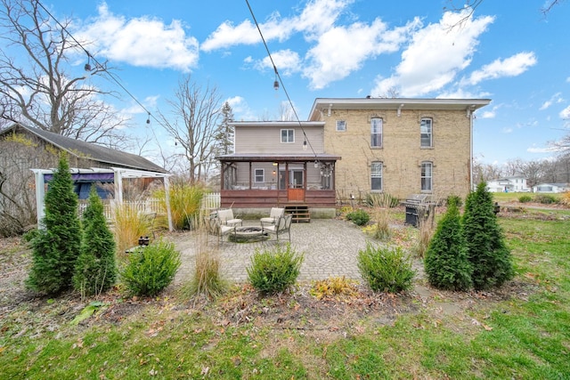 back of house with an outdoor fire pit