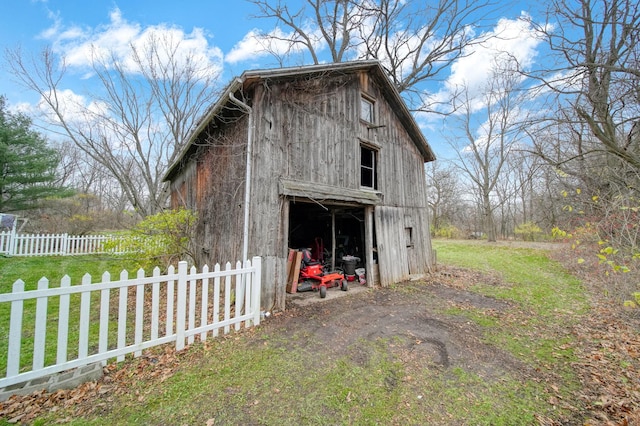 view of outbuilding with a lawn