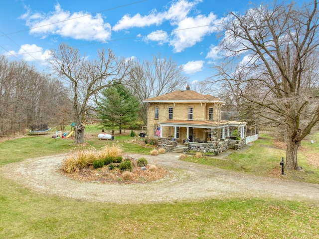 view of front facade with covered porch and a front lawn