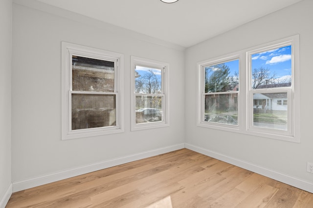 empty room with light hardwood / wood-style flooring