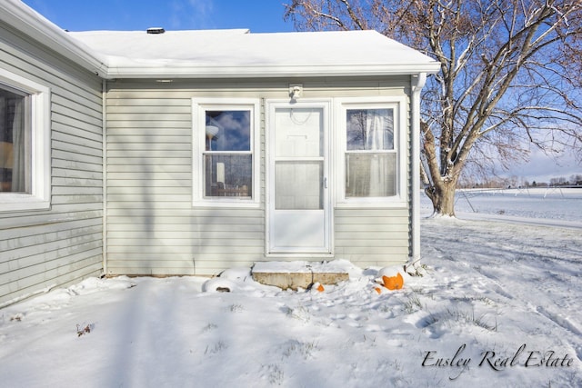view of snow covered property entrance
