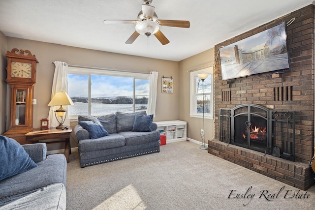 living area with baseboards, carpet floors, a ceiling fan, and a fireplace