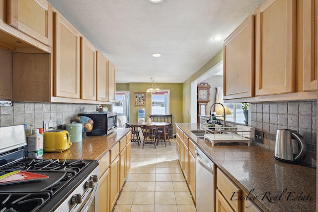 kitchen with stainless steel appliances, decorative backsplash, and plenty of natural light