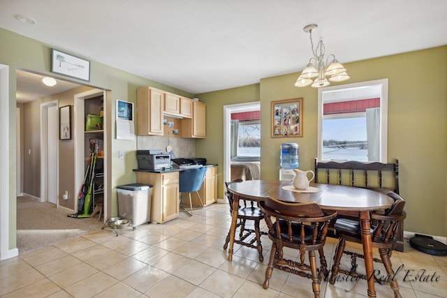 dining room with baseboards, light tile patterned floors, and an inviting chandelier