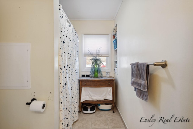 bathroom with baseboards, ornamental molding, a shower with curtain, and tile patterned floors