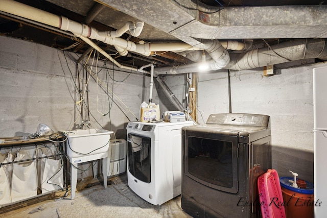 laundry area featuring washing machine and clothes dryer and laundry area