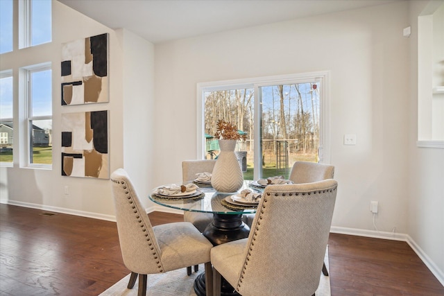 dining space with dark hardwood / wood-style flooring