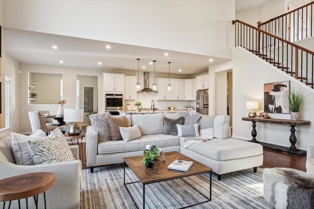 living room with dark hardwood / wood-style flooring and sink