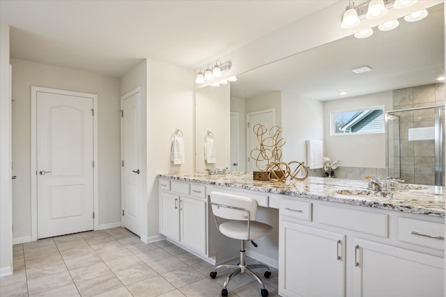 bathroom with tile patterned flooring, vanity, and walk in shower