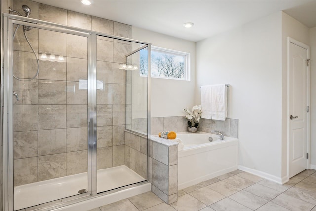 bathroom with separate shower and tub and tile patterned flooring