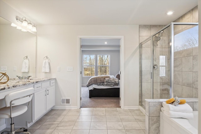 bathroom with tile patterned floors, a shower with door, and vanity