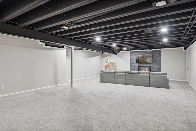 basement featuring carpet and a fireplace