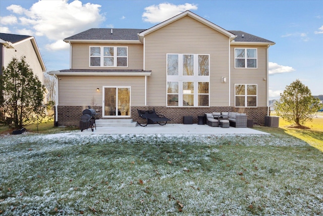 back of house featuring a lawn, a patio, and an outdoor hangout area